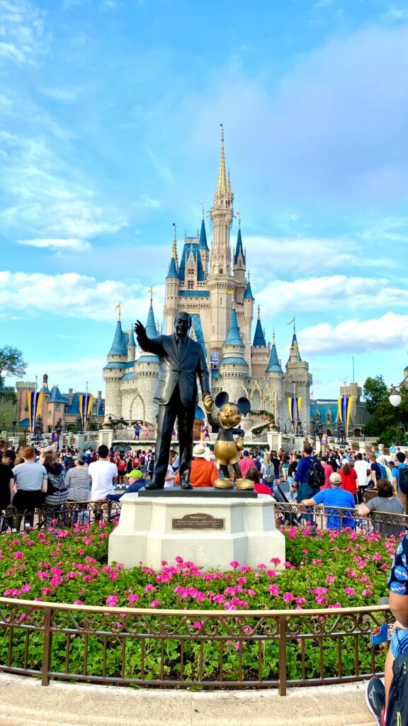 Walt Disney statue in front of Cinderella's Castle